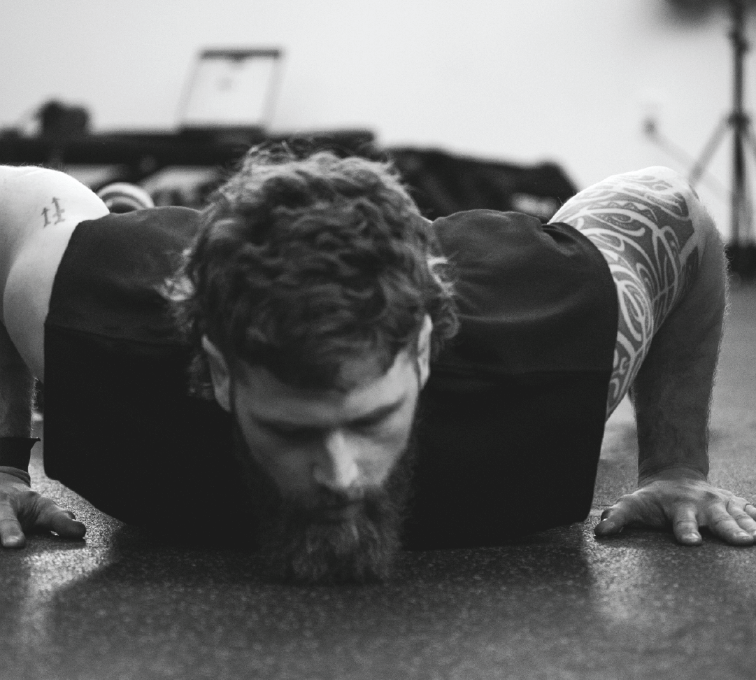 Athlete moving through lateral lunge with arms overhead, calm lighting. Mobility-focused WLD session.