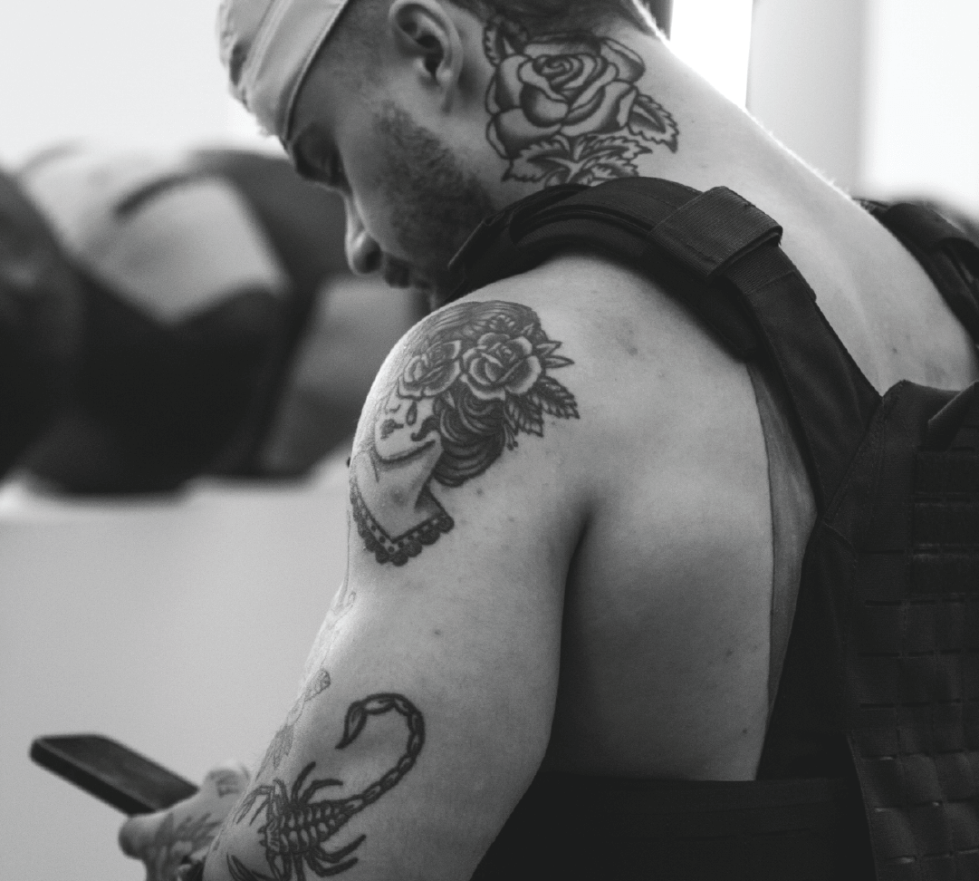 Black and White picture of a Hybrid Athlete wearing a Gorila Fitness Phantom Plate Carrier for Today's free workout of the WLD Online Program. 