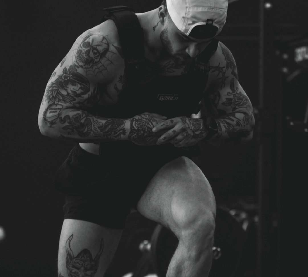 Athlete wearing a weighted vest transitioning into explosive step-ups with focused coordination.