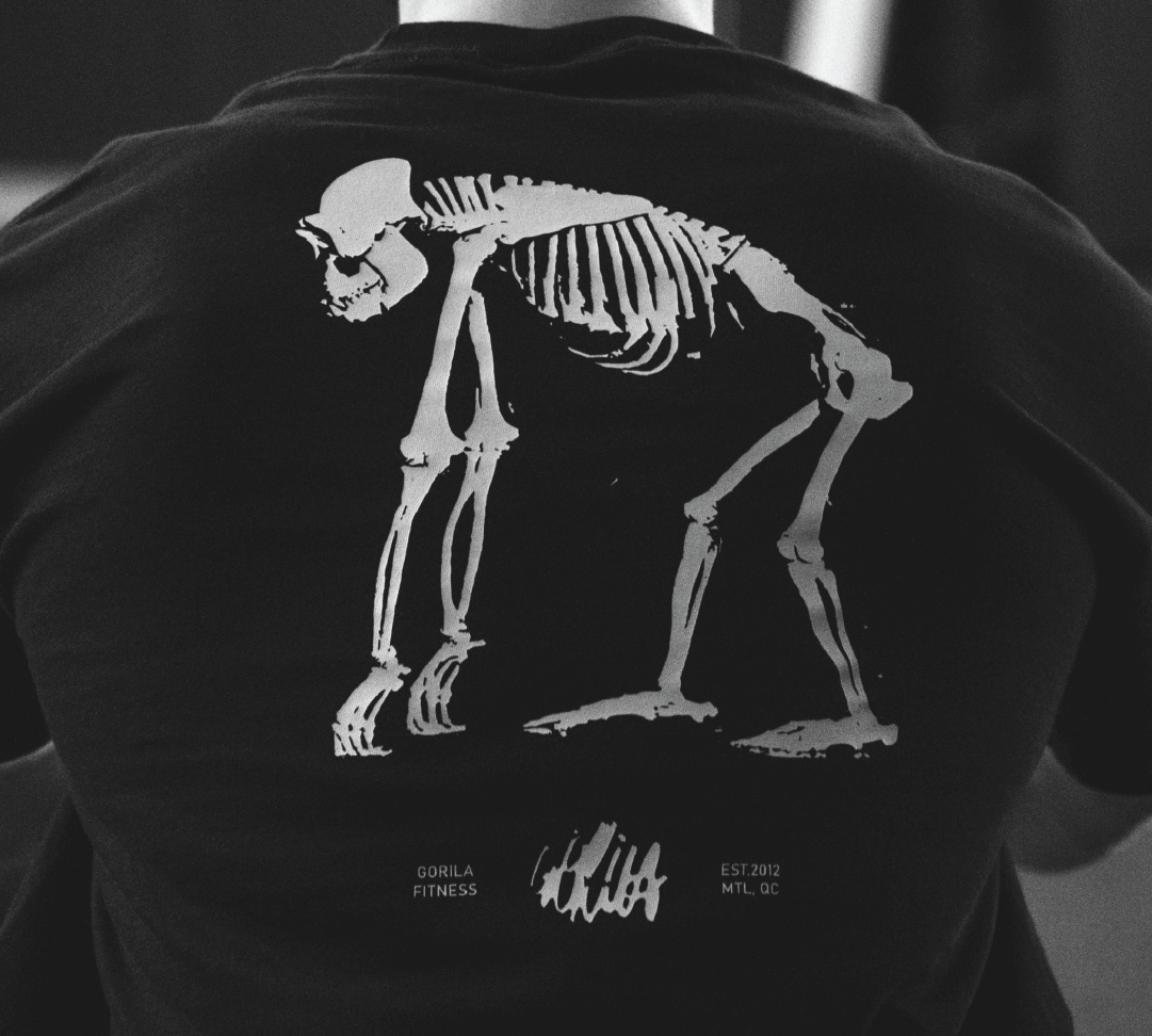 Athlete doing mobility work on floor with low lighting and calm posture. Free 30 days online programming.