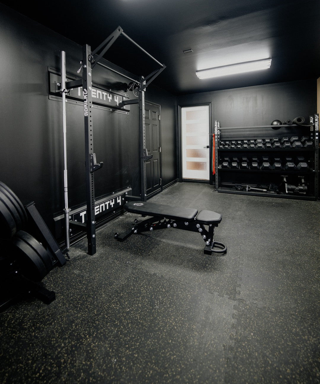 Black Home Gym on a Budget with Wall Mounted Squat Rack, Barbell, Plates and Dumbbells