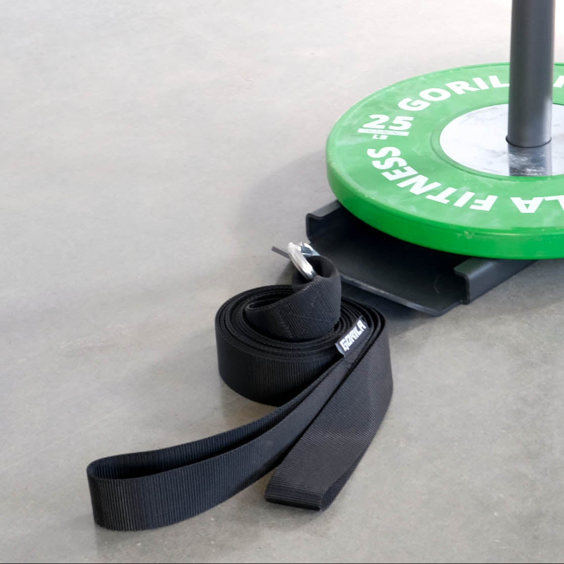 Gorila nylon sled strap attached to sled with 25 lb weight plate on white background