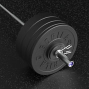 Close-up of Gorila barbell loaded with Ox bumper plates and spring collars on black gym floor – premium 290 lb RX bar and plate set with training bar