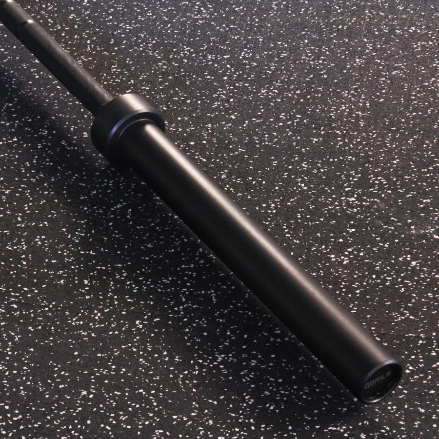 Close-up of the Gorila Men's Barbell smooth, matte black sleeve with minimal branding, designed for a seamless plate load experience.