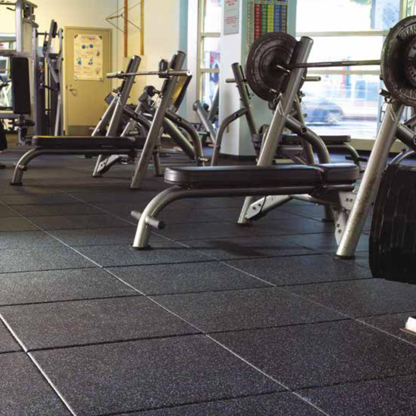 High-impact Regupol rubber gym tiles installed in a commercial weight training facility by Gorila Fitness Canada, ideal for CrossFit and Olympic lifting areas.