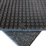 Regupol recycled rubber floor tile showing smooth wear layer and embossed molded underside for superior shock absorption and sound reduction, sold by Gorila Fitness Canada.