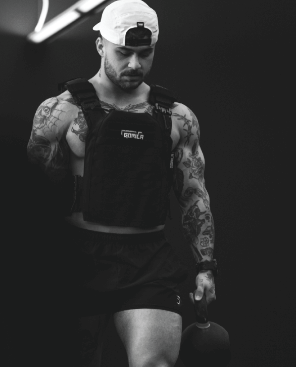 Athlete wearing Gorila Fitness weighted vest during kettlebell training, performance apparel and gear built for strength and endurance.