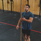 CrossFit athlete training on the Gorila Manila Rope during rope climbs at a functional gym.