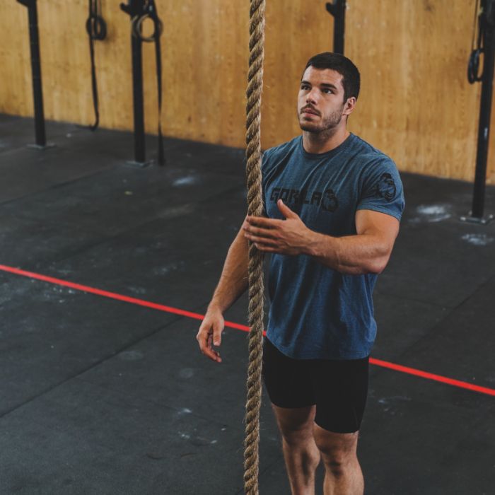 CrossFit athlete training on the Gorila Manila Rope during rope climbs at a functional gym.