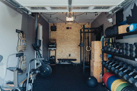 Basement home gym in Canada featuring a power rack and free weights