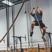 Crossfit Games athlete climbing a Gorila Manila Rope inside a Canadian training facility.