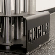 Side view of Gorila 5 Bar Holder showing precise laser-cut logo, reinforced base plate, and 7 & 11 gauge steel used for stable barbell organization.