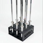 Gorila 9 Bar Holder loaded with Olympic barbells demonstrating secure upright storage, heavy-duty 7-gauge steel construction, and space-efficient design for professional gym setups.