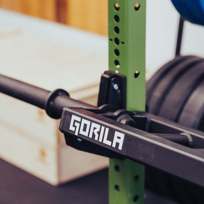 Gorila Alligator Football Bar mounted on power rack – compatible with standard 3x3 squat stands and designed for bench press and row variations