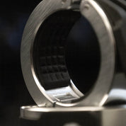 Extreme close-up of a Gorila Aluminium Barbell Collar showing the precision-machined aluminum interior and the textured rubber grip pattern inside the clamp, designed for maximum hold on Olympic barbells under heavy load.