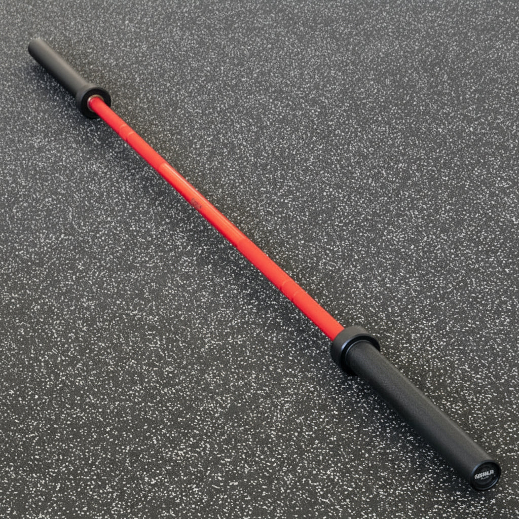 Gorila Bar Red Teflon Olympic barbell on black gym floor – premium red shaft and black sleeve finish offering Cerakote-like protection with vibrant color and high tensile steel performance