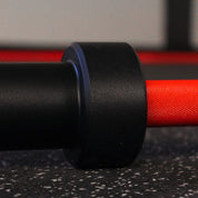 Grooves on sleeve detail of Gorila Bar Red Teflon barbell – medium grip texture designed for powerlifting, weightlifting, and CrossFit athletes seeking Cerakote-grade durability and precise control