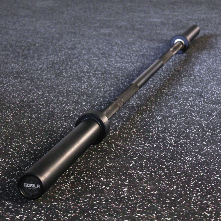 Full view of the Gorila Bar Teflon on gym flooring – durable 20KG barbell with 28MM shaft, dual knurl marks, and matte black PTFE coating.