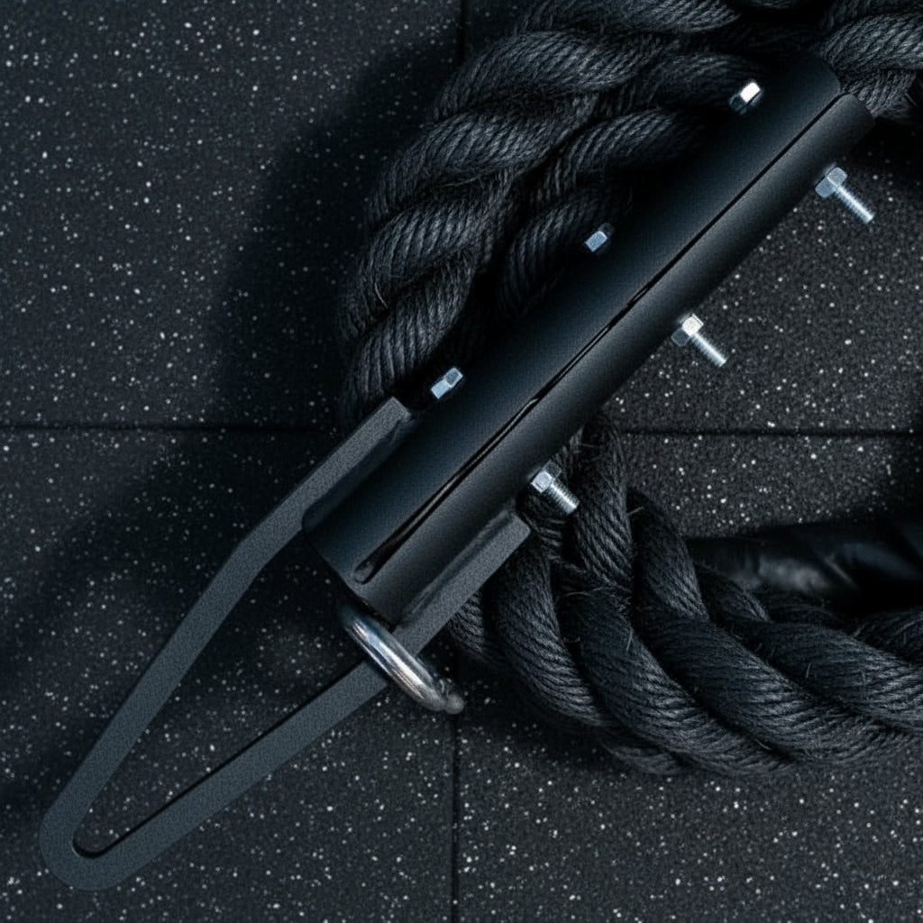 Close-up of the Gorila Blackline Climbing Rope hook resting on black rubber gym flooring, showing the matte finish and heavy-duty steel connector.