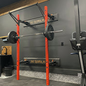 The Made in Canada Gorila Camo Rack custom color option in red finish in a black garage gym setup, with extensible pull-up bar
