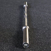 Stainless steel Gorila Ceros barbell with aggressive IPF knurling and grooved sleeves for powerlifting training.