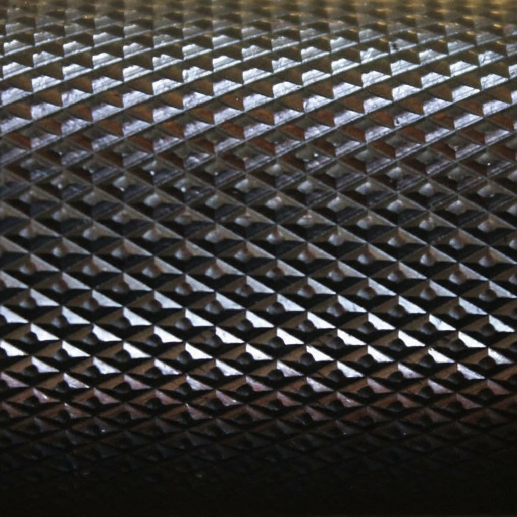 Macro close-up of the Gorila Ceros Power Bar knurling texture showing precise grip pattern for heavy lifts.