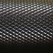 Macro close-up of the Gorila Ceros Power Bar knurling texture showing precise grip pattern for heavy lifts.