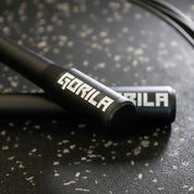 Close-up of Gorila CSR2 Speed Rope handle showing precision-machined aluminum grip and engraved Gorila logo for professional CrossFit and HIIT training.
