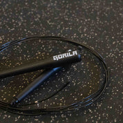 Detailed close-up of the Gorila CSR2 Speed Rope handle featuring matte black plastic construction, ergonomic grip, and engraved Gorila logo for elite CrossFit and Hyrox athletes.