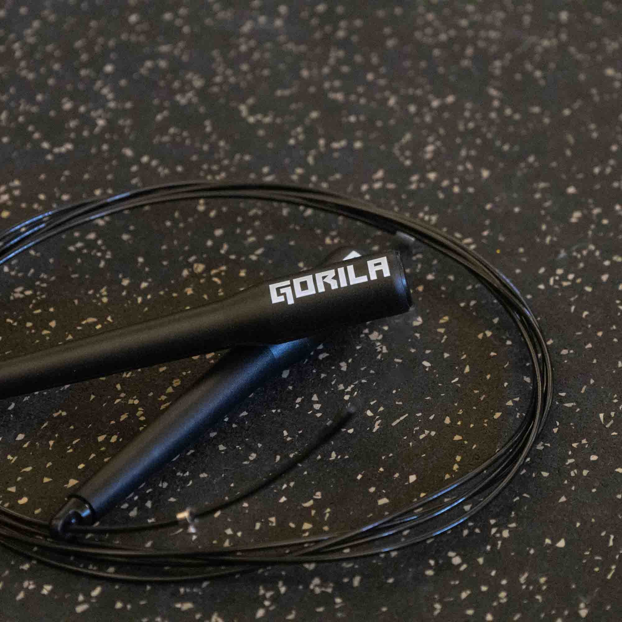 Detailed close-up of the Gorila CSR2 Speed Rope handle featuring matte black plastic construction, ergonomic grip, and engraved Gorila logo for elite CrossFit and Hyrox athletes.