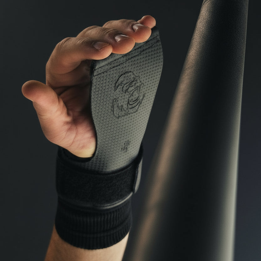 Action shot of an athlete using Gorila Death Grips during a pull-up bar workout, showing real use of premium hand protection grips for CrossFit Butterfly pull-ups