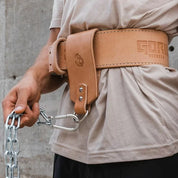Close-up of Gorila Dip Accessory Strap attached to lifting belt for weighted dips and pull-ups, showing secure leather and chain connection.