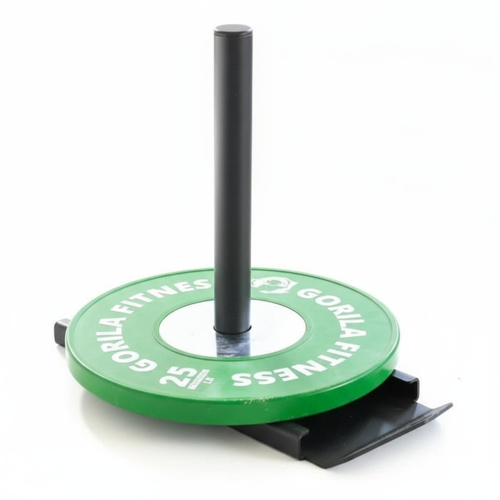 Gorila Falcon Sled loaded with green bumper plates for strength, power, and sprint training on turf or gym flooring.