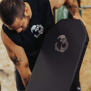 Athlete adjusting the Gorila Fitness adjustable incline bench, showcasing premium padding with embroidered gorilla logo, made in Canada