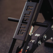 Close-up of Gorila Fitness logo cutout on adjustable bench frame, black powder-coated steel with numbered incline levels made in Canada