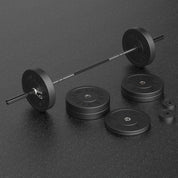 Complete set of Olympic Barbell with 290 lb weight plates on a dark surface