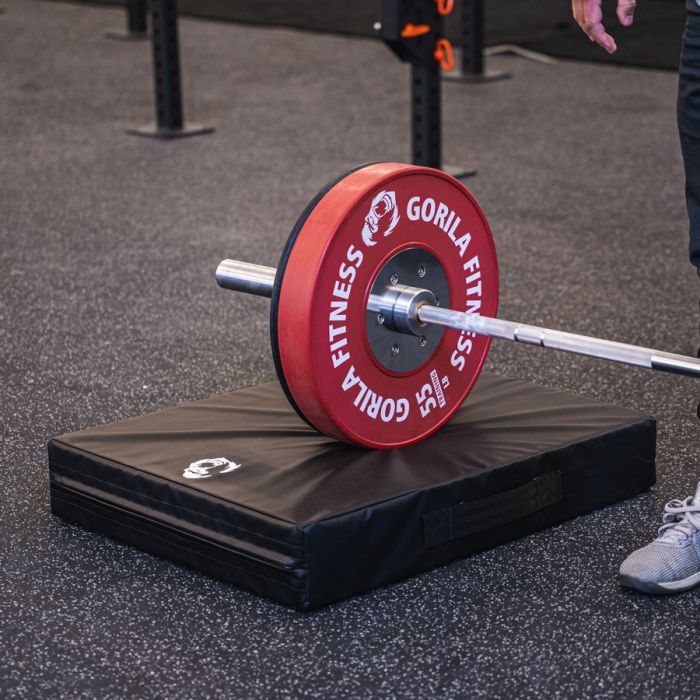 Barbell with bumper plates dropped on Gorila Fitness drop pads, demonstrating noise control and floor protection, made in Canada
