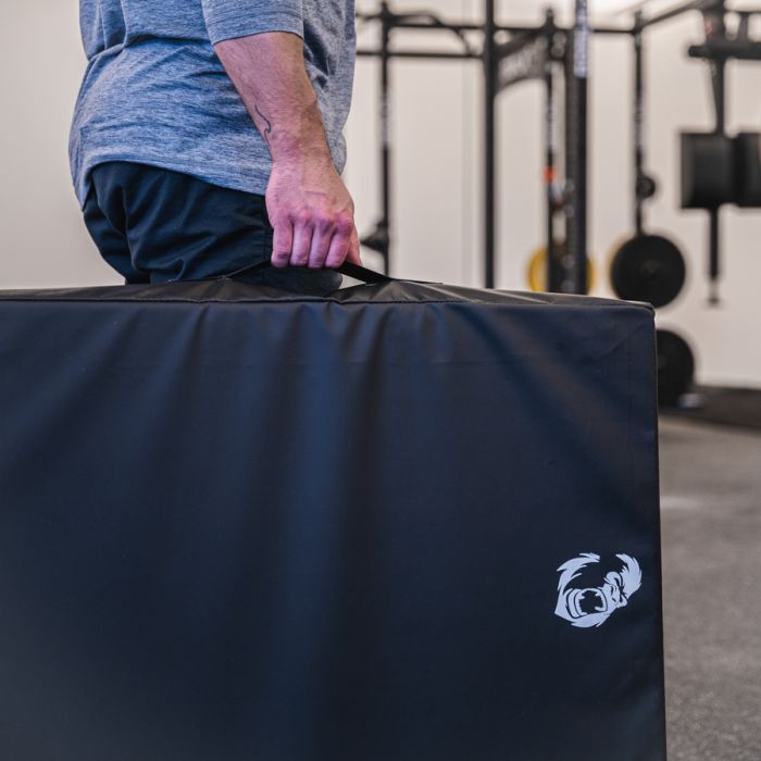 Gorila Fitness drop pads being moved easily using integrated carrying handles, compact design ideal for home or commercial gyms