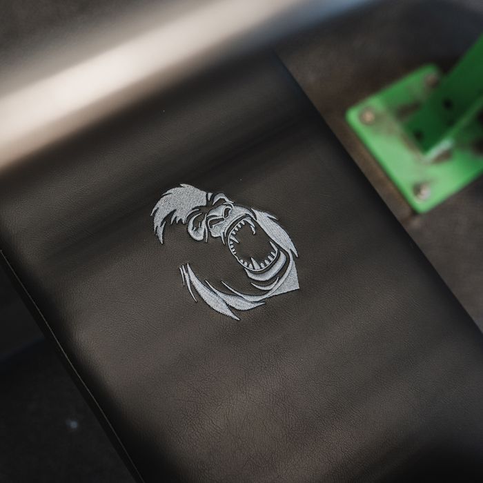 Close-up of Gorila Fitness flat bench pad with embroidered gorilla logo, showing premium texture and craftsmanship.