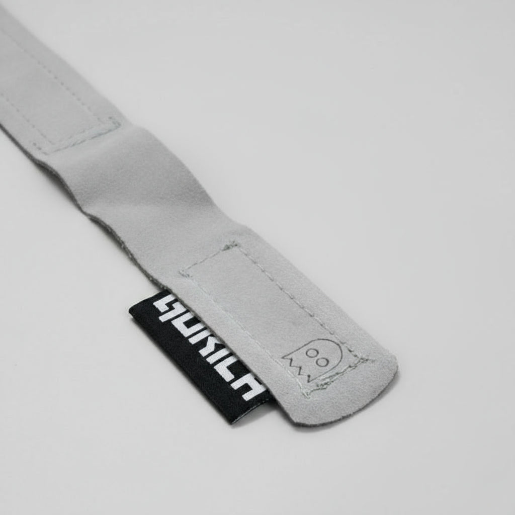 Close-up of Gorila Ghost Grips showing durable Clarino microfiber construction and reinforced wrist strap. Ghost logo.