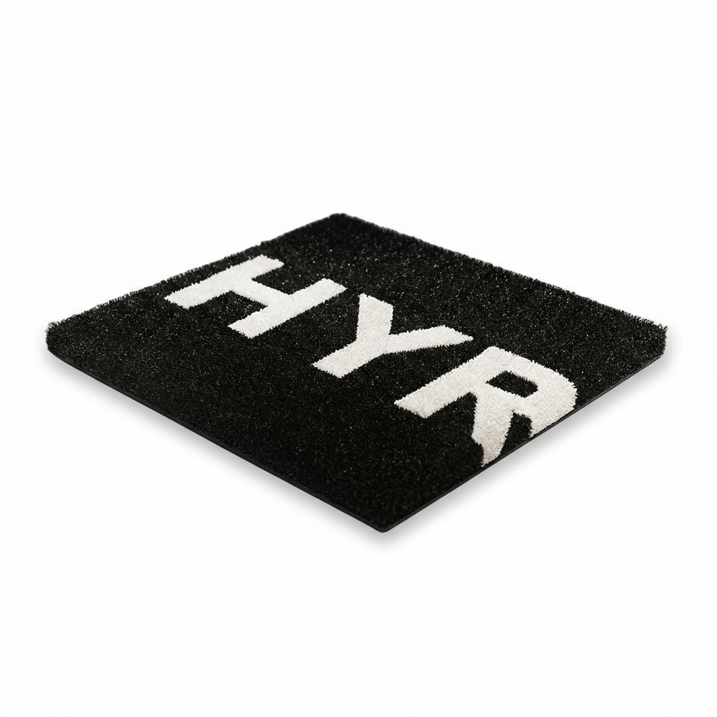 Black custom HYROX turf for gyms by Gorila Fitness, showing standard HYROX lane width and crisp white logo marking. Premium athletic turf designed for hybrid training and gym owners across Quebec, Ontario, and New Brunswick. Available in custom colors, lane configurations, and personalized branding.