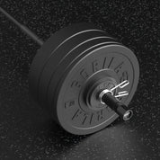 Barbell with weight plates on a dark textured background