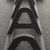 Close-up of Gorila HPS Storage separators – heavy-duty steel dividers designed to keep Olympic plates neatly organized on the portable matte black rack, showing precision welds and durable powder-coated finish