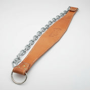 Gorila Leather Dip Belt displayed on wood surface highlighting vegetable-tanned leather finish and heavy-duty steel chain.