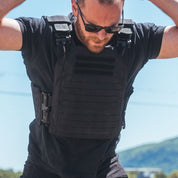 Athlete warming up doing burpees and stretching while wearing the Phantom Plate Carrier 2.0 before a ruck walk