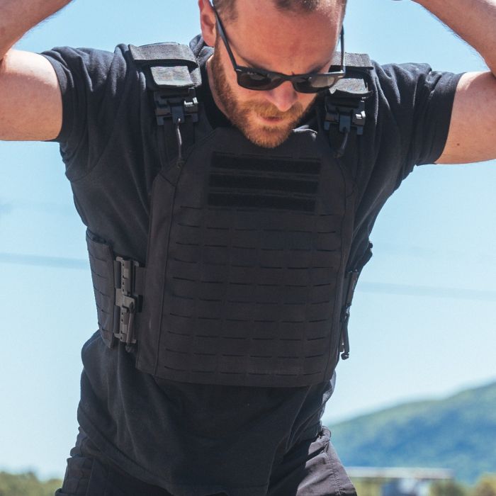 Athlete warming up doing burpees and stretching while wearing the Phantom Plate Carrier 2.0 before a ruck walk