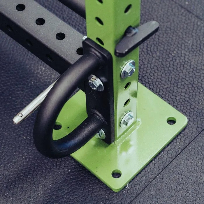 Close-up of Gorila Rope Attachment Anchor bolted to a green rack upright with 5/8 inch hardware, highlighting the laser-cut plate and 1.25 inch tubing.