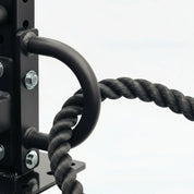 Gorila Rope Attachment Anchor mounted on a power rack with battle rope looped through the steel ring, showing correct setup for waves and slams.