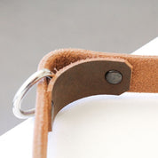 Close-up of Gorila tricep strap showing welded steel D-ring and reinforced stitching for secure attachment and durability.