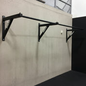 Linked Gorila TRUNK Pull-Up Systems installed in a school gym, creating a continuous pull-up station for group training